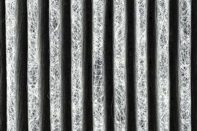A macro shot of the surface rectangular, carbon cabin filter. fibers arranged in vertical lines.