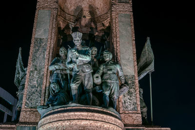 Low angle view of statue against historic building