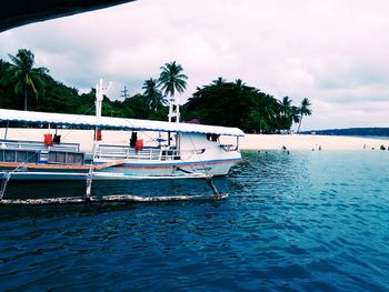 Boat moored in sea against sky