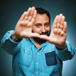 Close-up portrait of a man gesturing