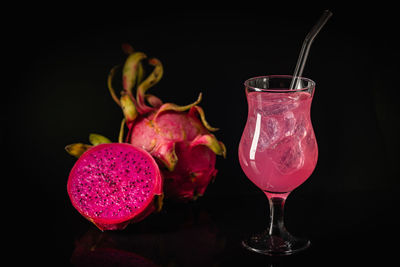 Close-up of drink on table against black background