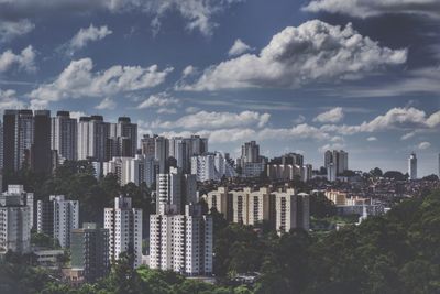 Cityscape against cloudy sky