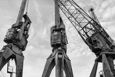 Low angle view of crane against sky