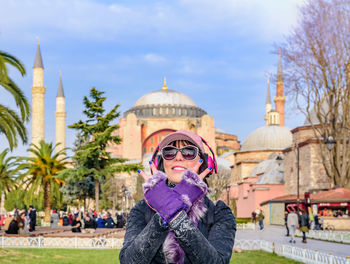 Smiling woman standing against hagia sophia museum