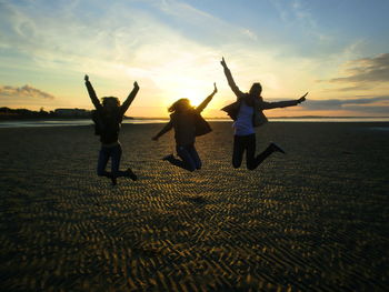 People on beach at sunset