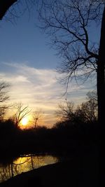 Scenic view of lake against sky at sunset