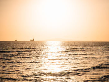 Scenic view of sea against orange sky