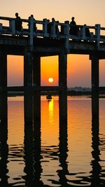 Pier on sea at sunset