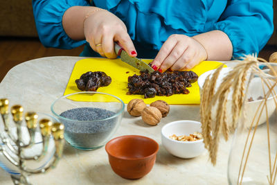 Midsection of woman holding food on table