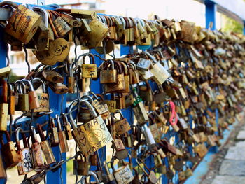 Padlocks hanging on railing