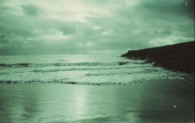 View of calm sea against cloudy sky