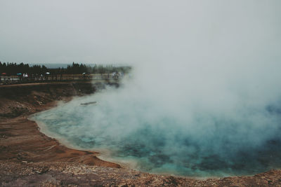 Smoke on hot spring against sky