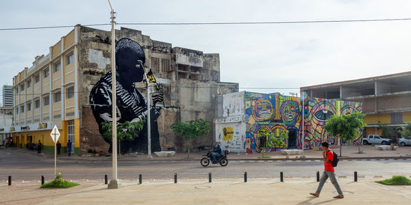 Statue by street against buildings in city