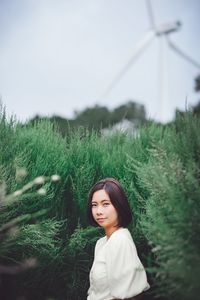 Portrait of woman standing on field