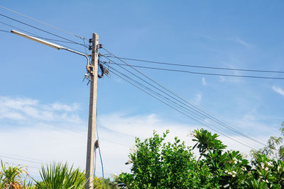 Low angle view of electricity pylon against sky