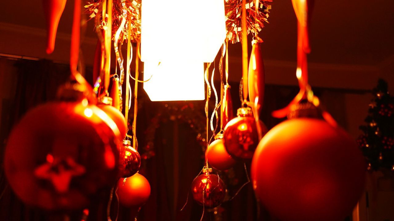 illuminated, indoors, religion, lighting equipment, decoration, celebration, hanging, red, lantern, spirituality, cultures, tradition, place of worship, christmas, low angle view, candle, close-up, christmas decoration, lit