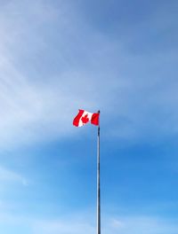 Low angle view of flags flag against sky