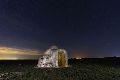 Scenic view of field against sky at night