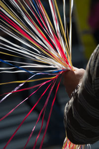 Close-up of hand holding multi colored decoration