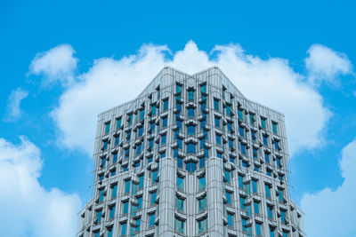 Low angle view of modern building against blue sky