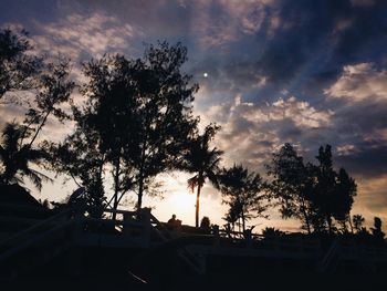 Silhouette trees against sky during sunset