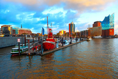 Boats in sea against cloudy sky