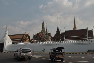 Vehicles on road against buildings