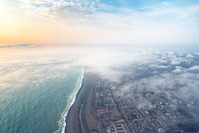 High angle view of cityscape by sea against sky