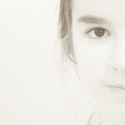 Close-up portrait of a young woman over white background