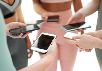 Midsection of woman using mobile phone