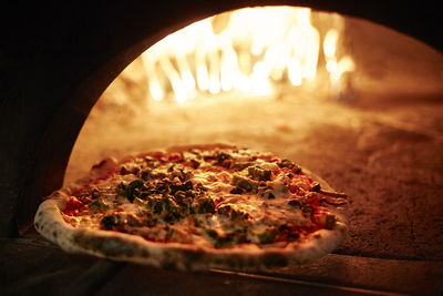 Close-up of pizza by oven