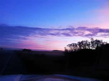 Silhouette trees against sky during sunset