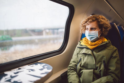 Portrait of mid adult man seen through train window