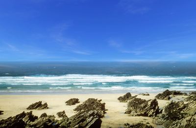 Scenic view of sea against blue sky