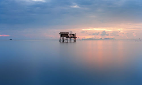 Scenic view of sea against sky at sunset