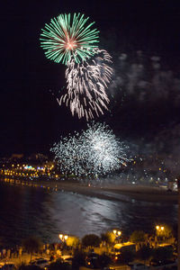 Low angle view of firework display at night