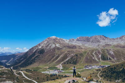 Scenic view of mountains against blue sky