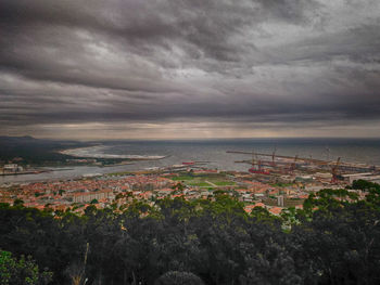 High angle view of cityscape against cloudy sky