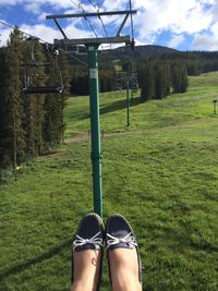 Low section of woman on field