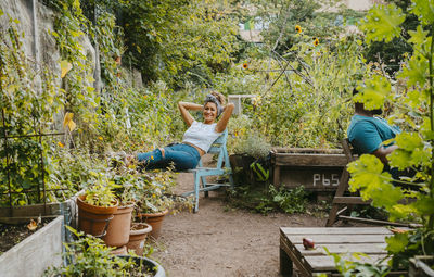 Female and male environmentalists resting in urban farm