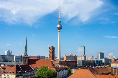 The famous tv tower of berlin with the town hall on a sunny day