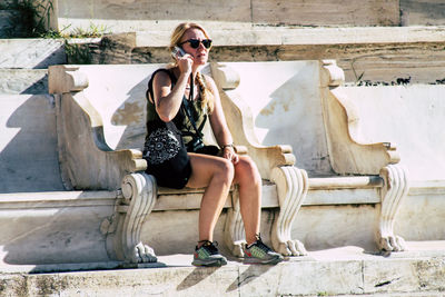 Woman sitting by sculpture