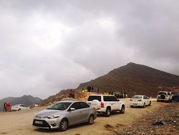 Cars on mountain against sky