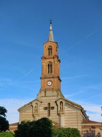 Low angle view of clock tower against sky