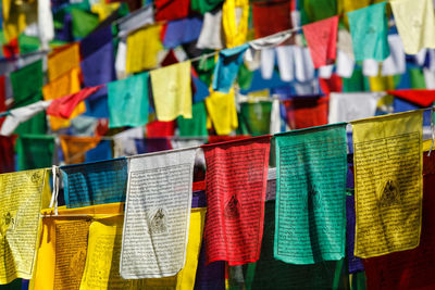 Close-up of multi colored flags hanging at market stall