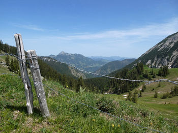 Panoramic view of mountains wirh barb wire fence