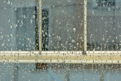 Full frame shot of wet glass window in rainy season