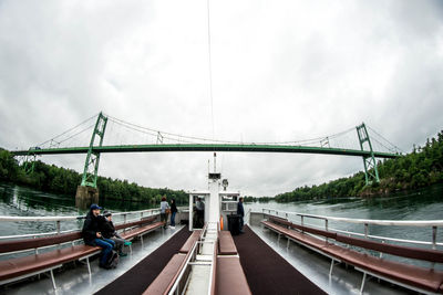 Man on bridge against sky