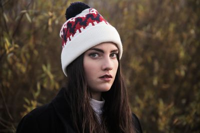 Portrait of young woman in hat