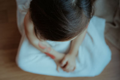 High angle view of woman relaxing on bed at home